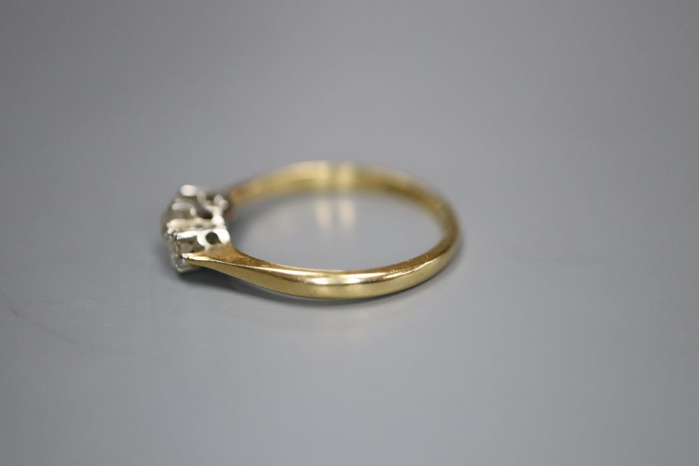 An 18ct & Pt, three stone diamond ring, size M/N, gross 1.8 grams.